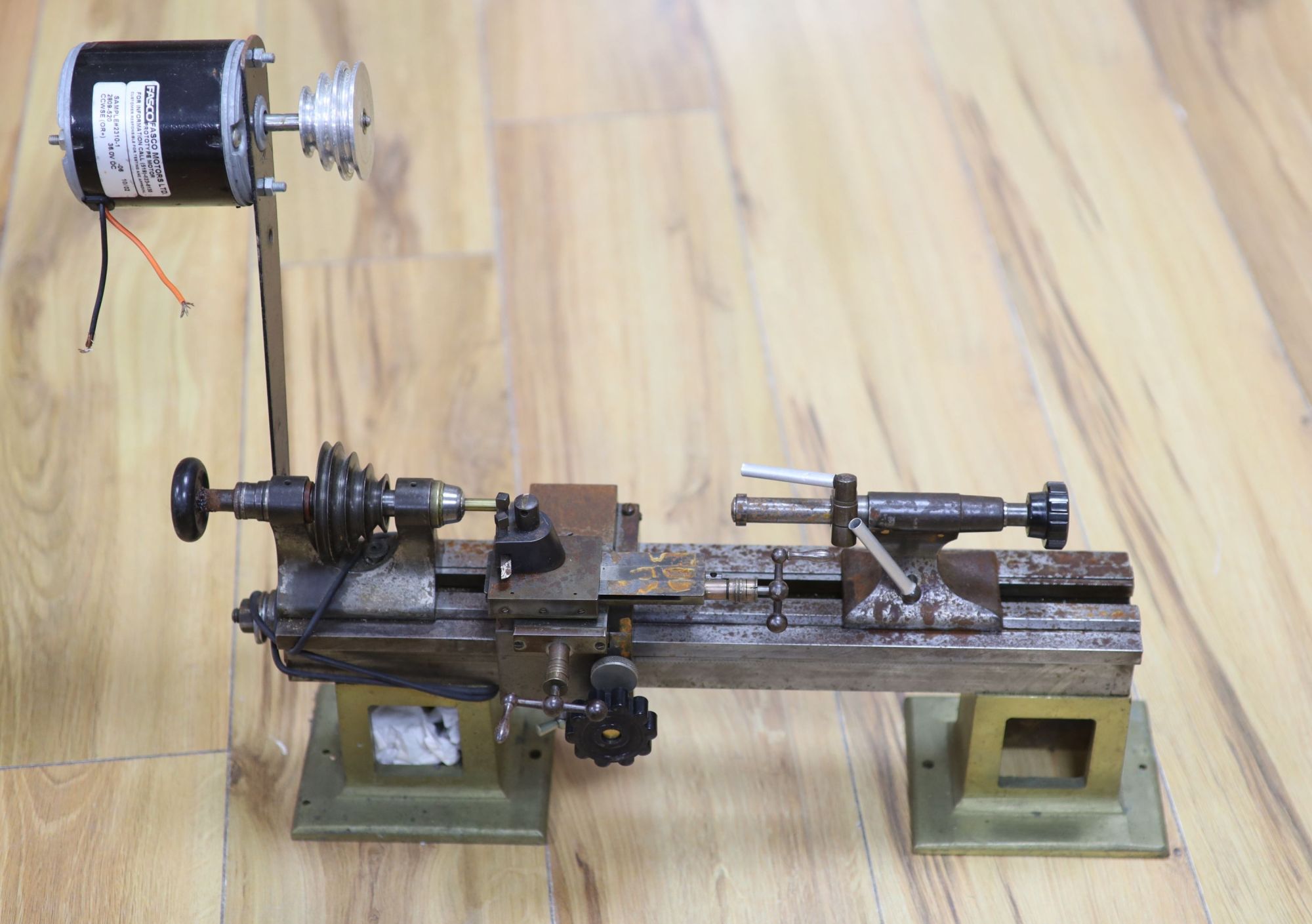 Clockmakers tools - a steel lathe with two brass supports, no makers mark, 44cm, with Fasco motor attachment